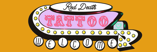 Tattoo parlor sign with 'Red Death Tattoo' and 'Welcome' text on a yellow background